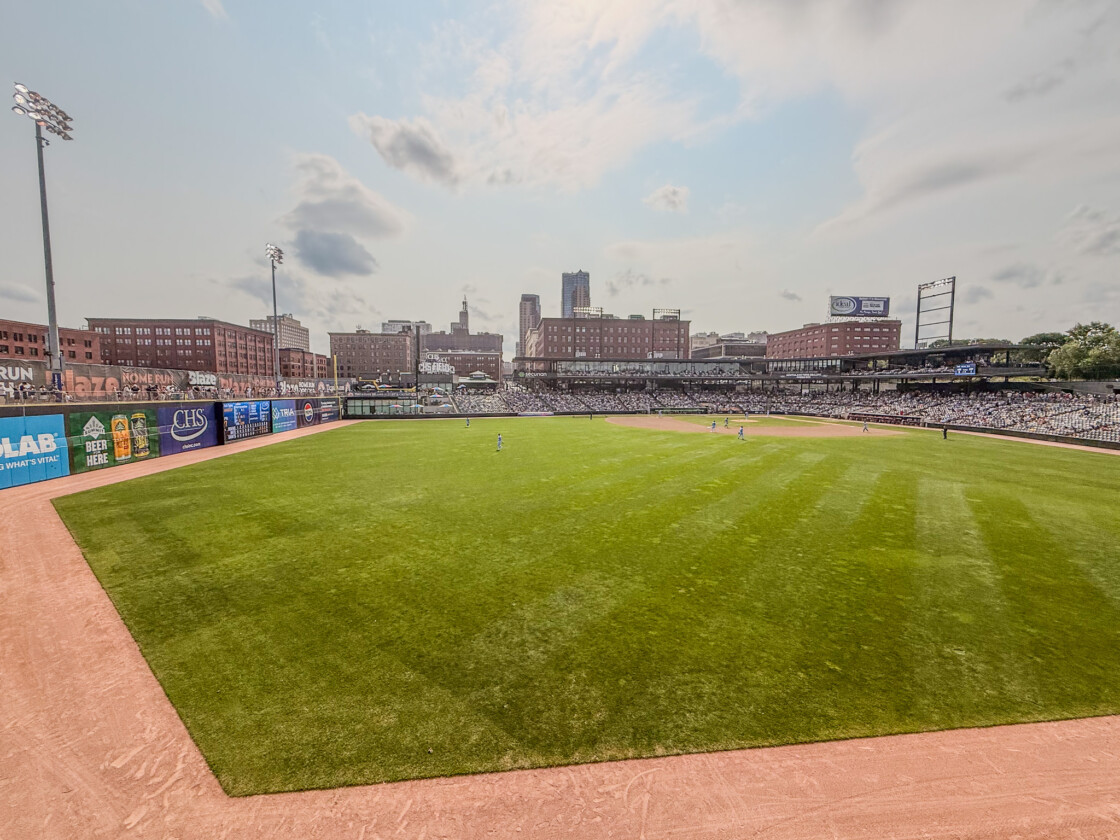 CHS Field baseball game in Saint Paul, Minnesota, with skyline and packed stands.
