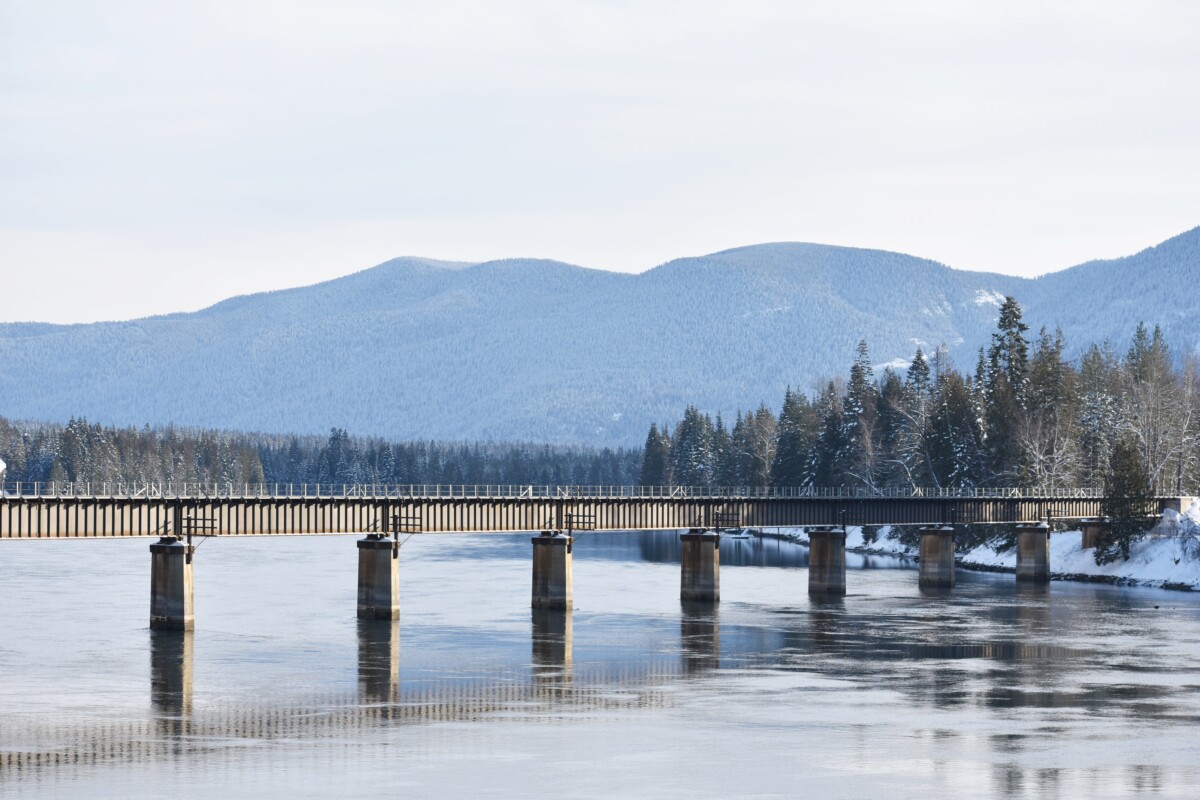 Mountain range view and train bridge over the Clark Fork River in Idaho