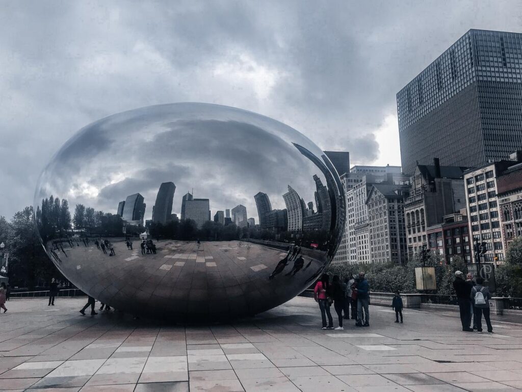 Cloud Gate sculpture reflecting Chicago skyline at Millennium Park