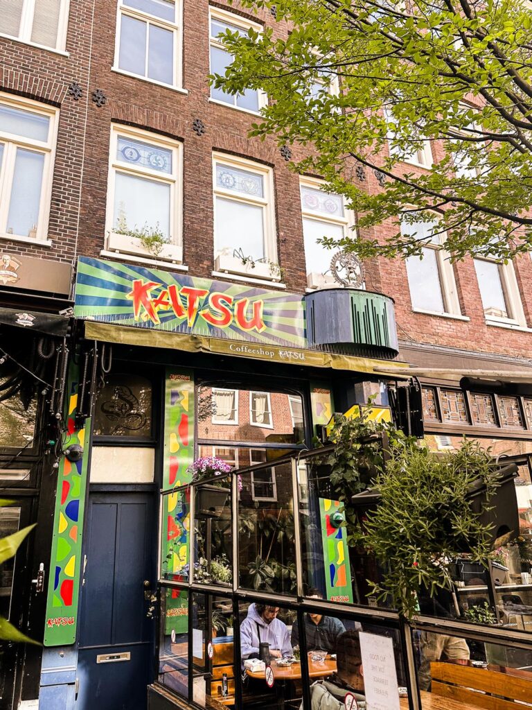 Coffeeshop Katsu facade in Amsterdam, showcasing Dutch architecture and vibrant storefront