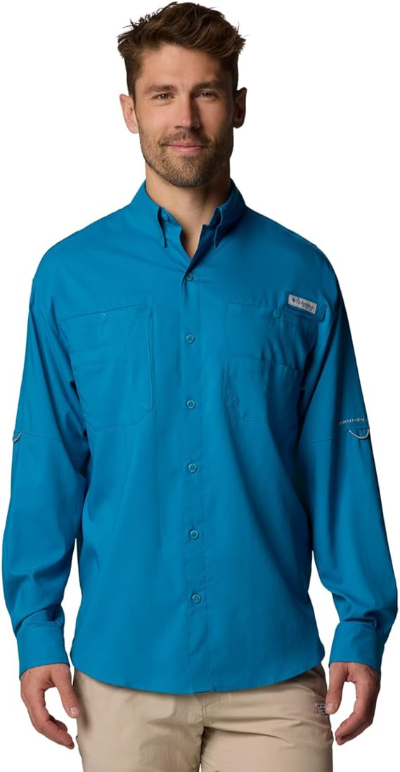 Man in blue Columbia PFG Tamiami II Long Sleeve Shirt and khaki pants, outdoors-ready style.