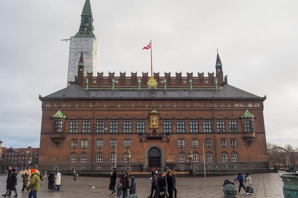 Visitors crossing City Hall Square in front of Copenhagen City Hall