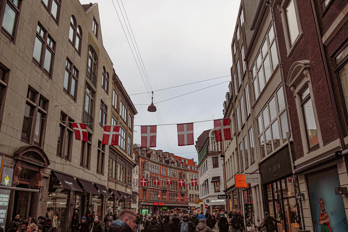 Copenhagen bustling shopping street with Danish flags