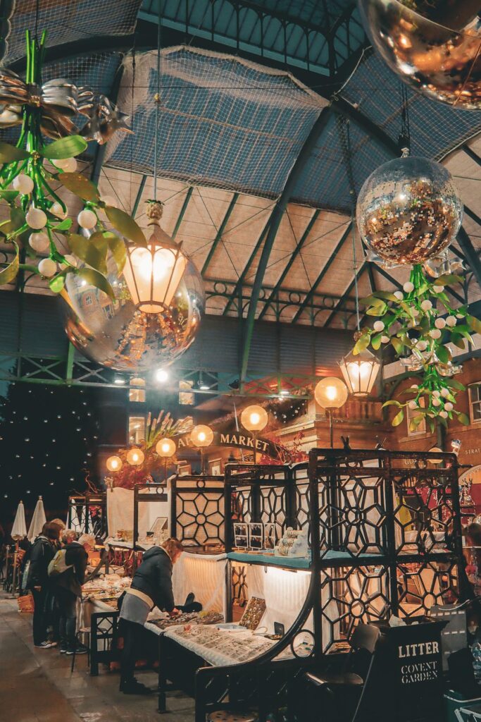 Covent Garden Market, London - Vibrant activity, twinkling lights, and bustling atmosphere capture historic and cultural hotspot.
