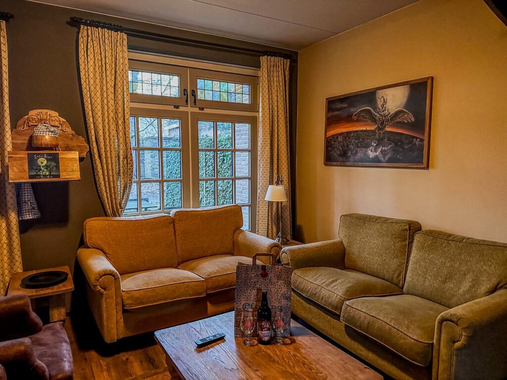 Cozy living room in Efteling Bosrijk Village House with themed wall art and personalized welcome package.