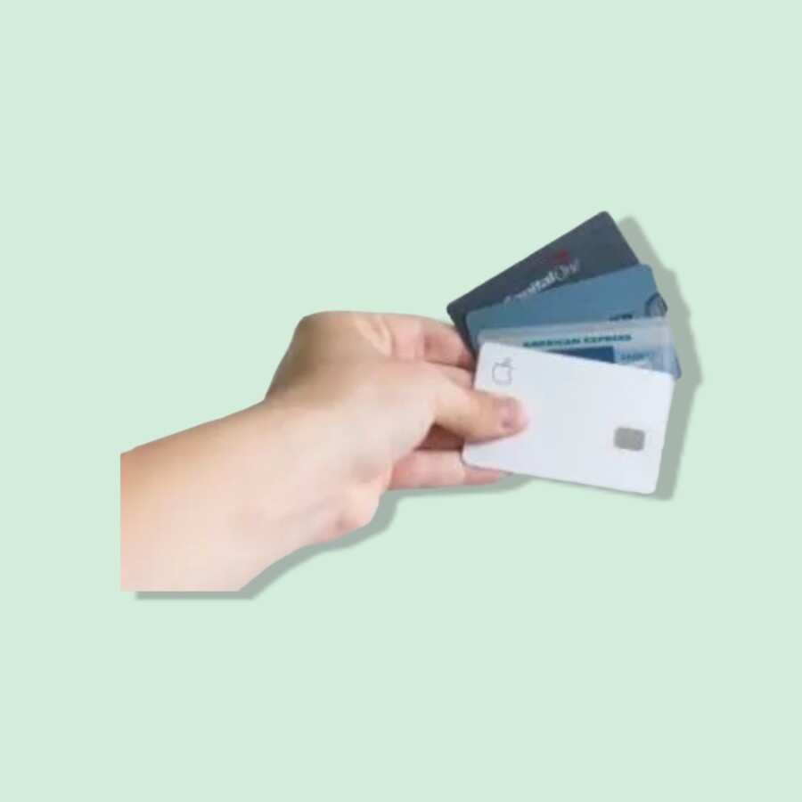 Hand holding different debit and credit cards