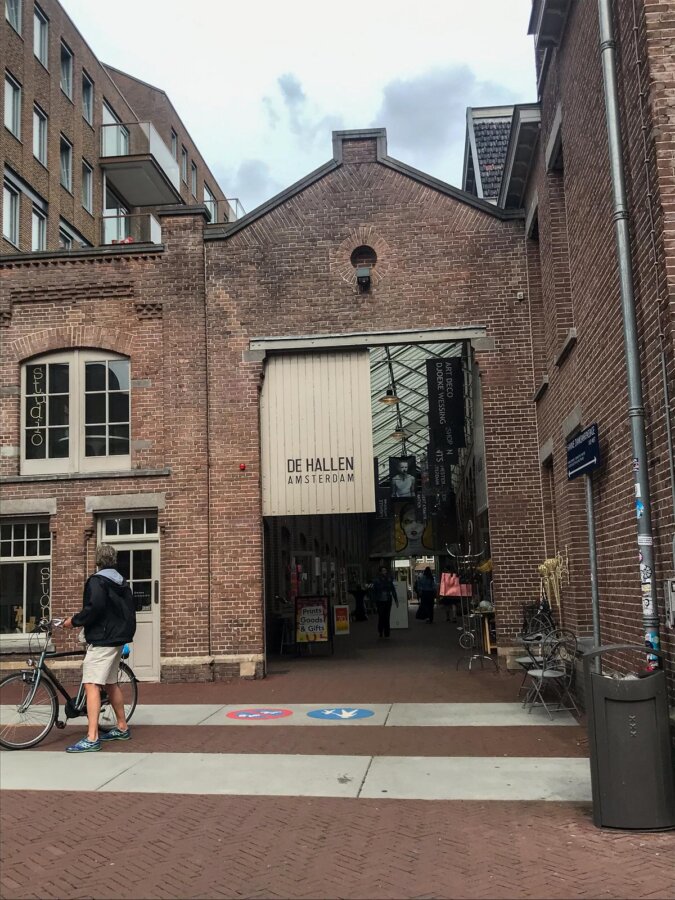 Entrance to Foodhallen Amsterdam with visitor and bike