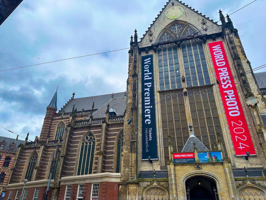 De Nieuwe Kerk in Amsterdam with World Press Photo Premiere banners, showcasing historic Gothic architecture and contemporary cultural events.