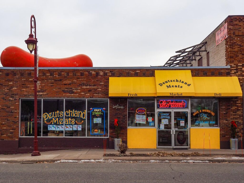 Deutschland Meats, Lindstrom, Minnesota: iconic giant sausage sculpture atop butcher shop storefront.