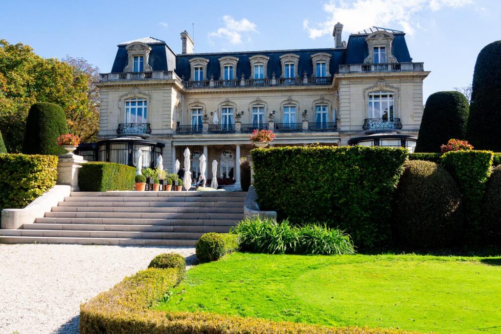 5-Star Domaine Les Crayères Hotel in Reims with lush gardens and elegant terrace.
