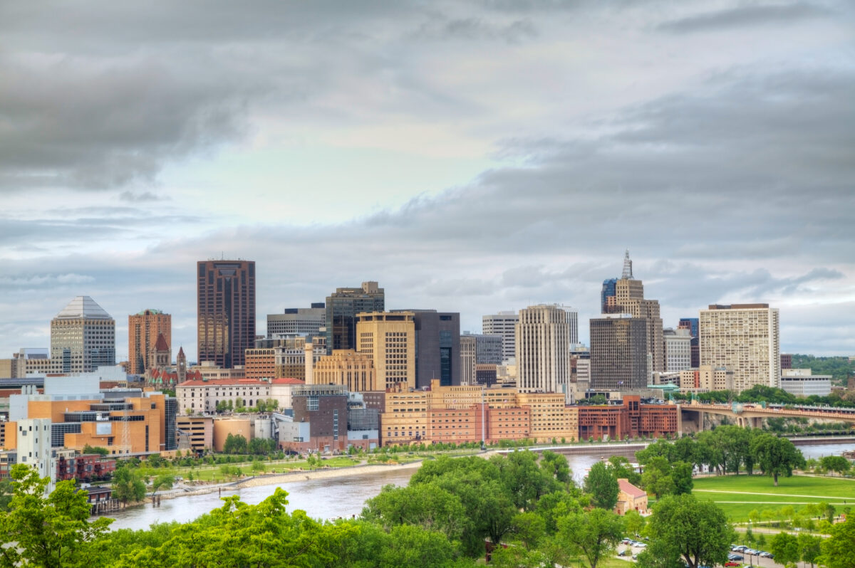 Downtown St. Paul skyline along the Mississippi River with riverfront park and bridge.