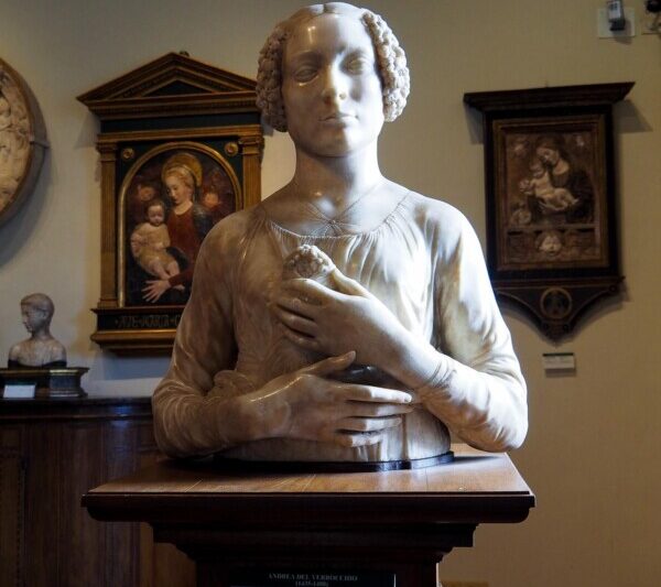 Elegant Renaissance marble bust in Florentine museum, showcasing lifelike detail and emotional expression.