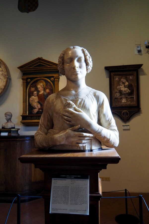 Elegant Renaissance marble bust in Florentine museum, showcasing lifelike detail and emotional expression.