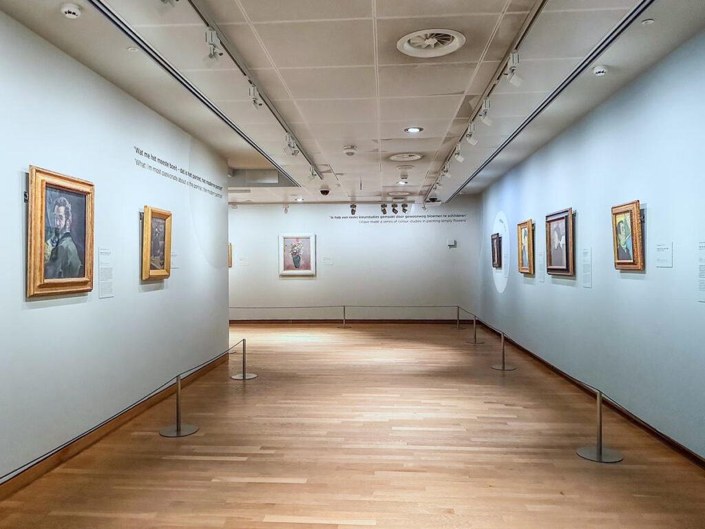 Empty Van Gogh Museum gallery interior with vibrant artworks, Amsterdam