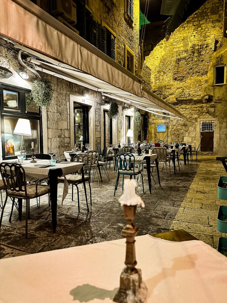 Enchanting Alfresco Dining Experience at Mazzgoon, Split, Croatia - Mediterranean restaurant ambiance with historic charm and warm lighting.