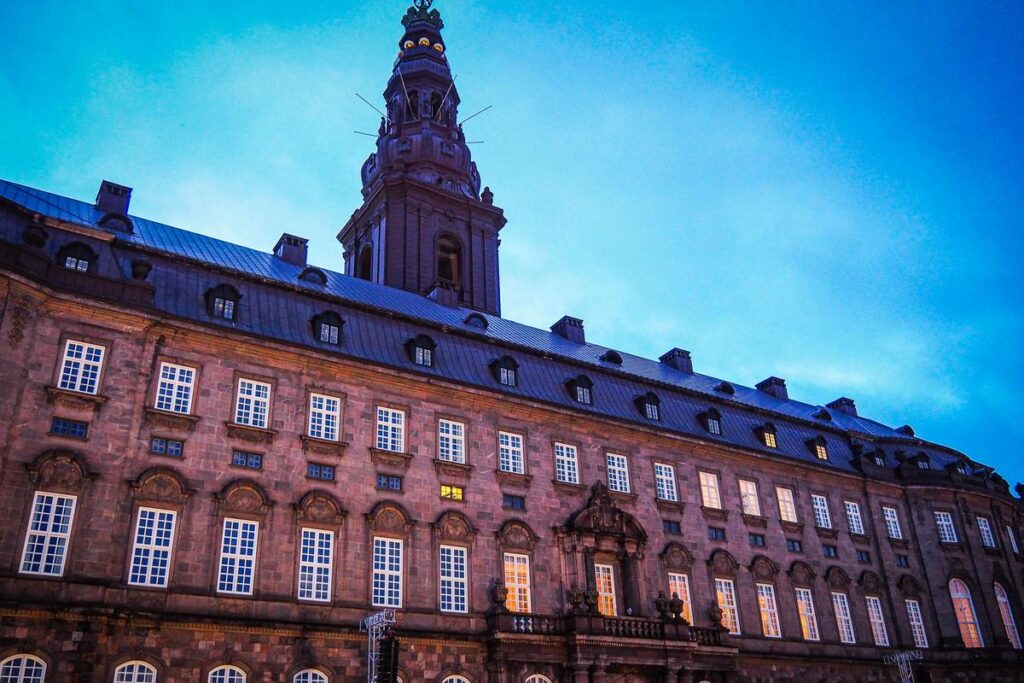 Christiansborg Palace illuminated at dusk in Copenhagen