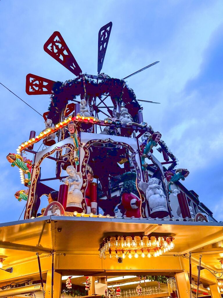 Enchanting German Christmas market stall with festive decorations and Christmas pyramid.