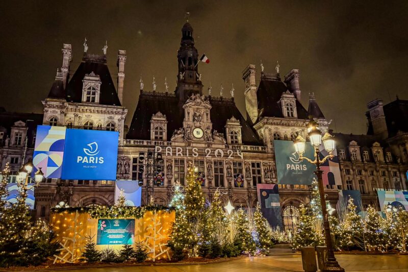 Enchanting night view of Hotel De Ville celebrating Paris 2024 with festive decorations