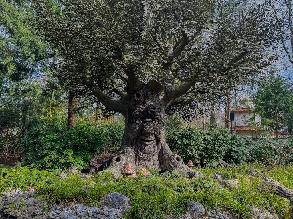 An animatronic talking tree in the lush Fairy Tale Forest at Efteling Theme Park, The Netherlands.