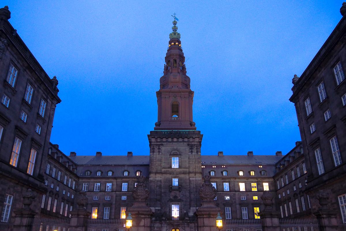 Twilight view of Christiansborg Palace with illuminated facade in Copenhagen