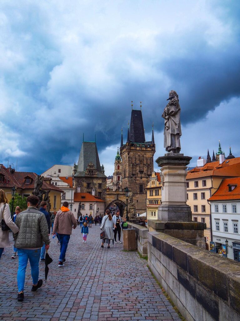 Iconic Charles Bridge with dramatic sky and historic Prague cityscape