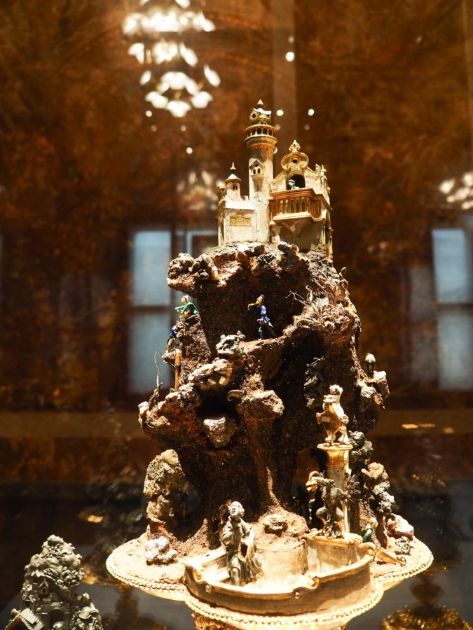 Exquisite antique sculpture at Kunsthistorisches Museum, Vienna: Intricate, opulent artwork with miniature castle and figures in period attire.