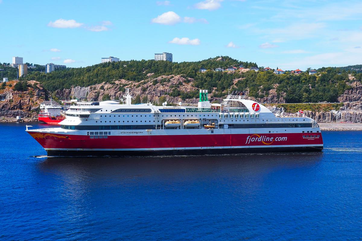 Fjord Line ferry cruising through Norwegian waters with scenic coastal cliffs in the background