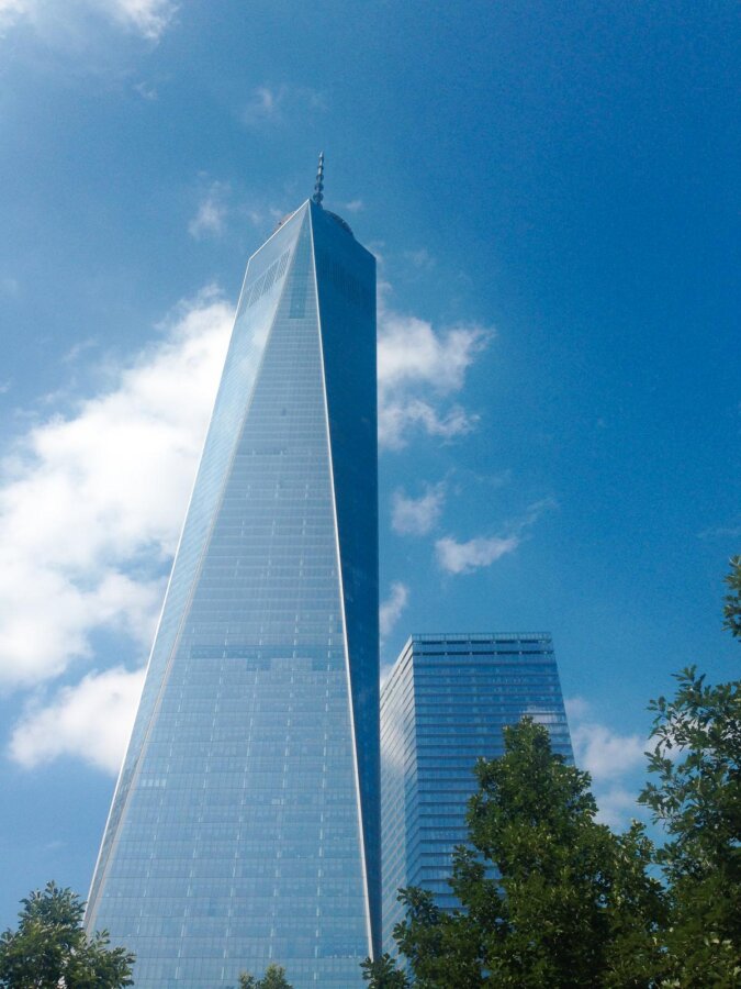 Freedom Tower soaring above NYC against blue sky