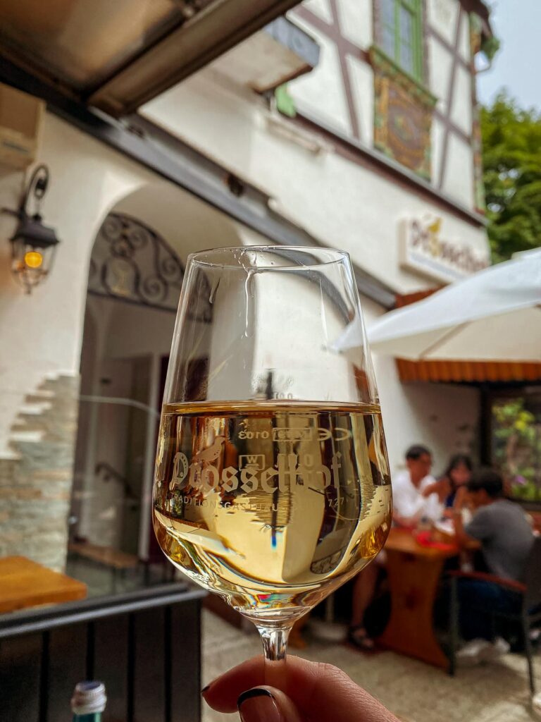 Glass of golden Riesling wine from a traditional German vineyard.