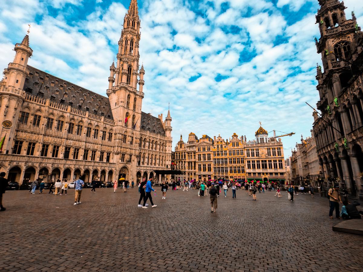 Grand Place in Brussels with historic guildhalls and bustling tourism.