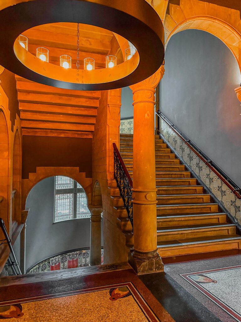 Grand Staircase and Chandelier at Conservatorium Hotel, Amsterdam - Luxury interior with warm lighting and historical architectural elegance