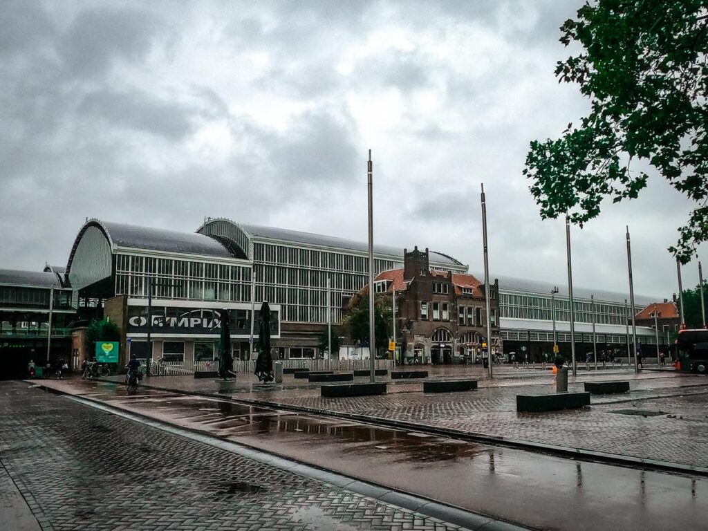 Haarlem Central Station on a rainy day, showcasing Dutch architecture and urban commuter lifestyle