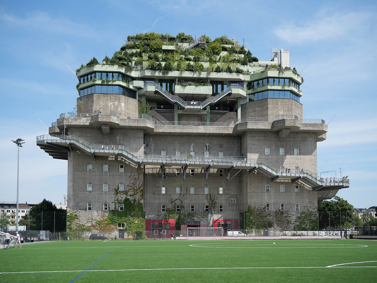 Hamburg landmark concrete bunker and monument with rooftop garden by soccer field.