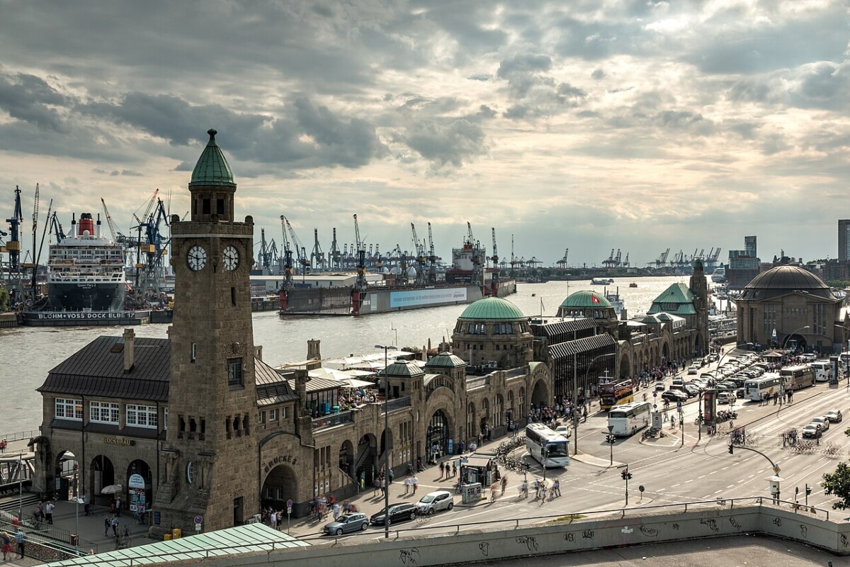 Hamburg landmarks: harbor clock tower, historic monuments, and port cranes.