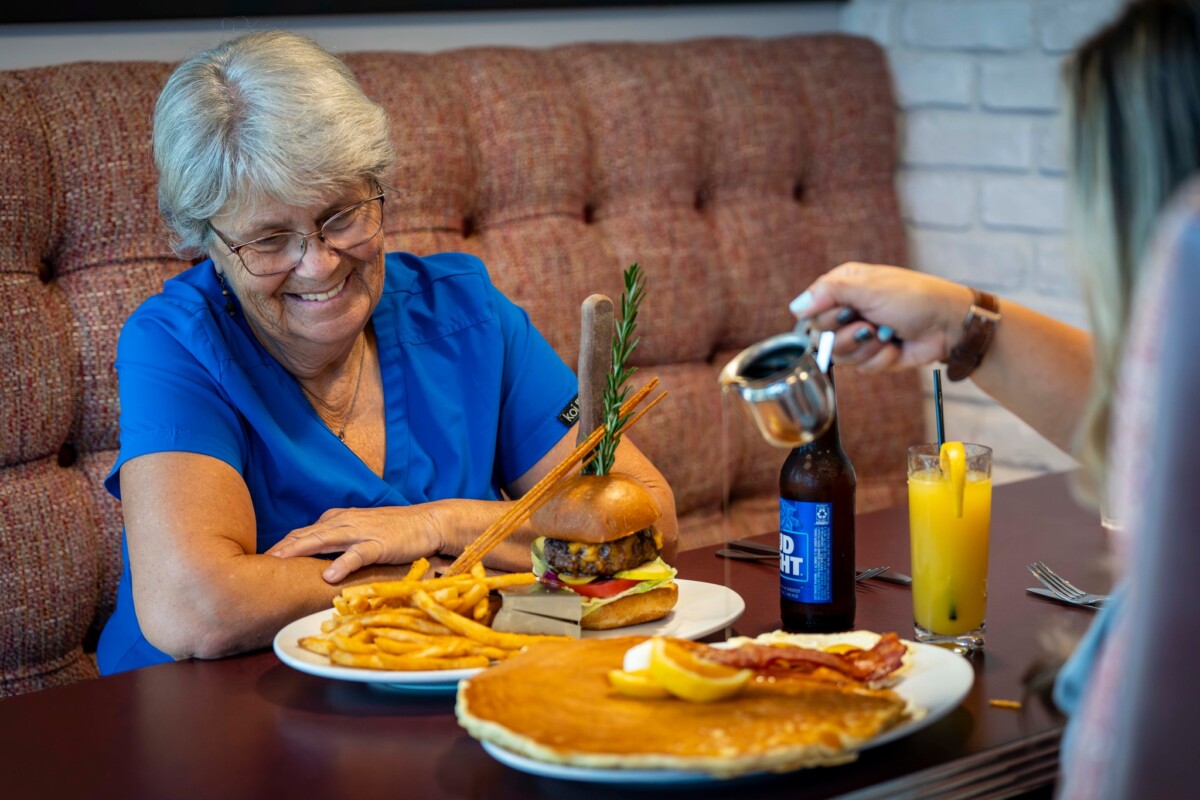 An old lady enjoying the food served at Hash House A Go Go Orlando