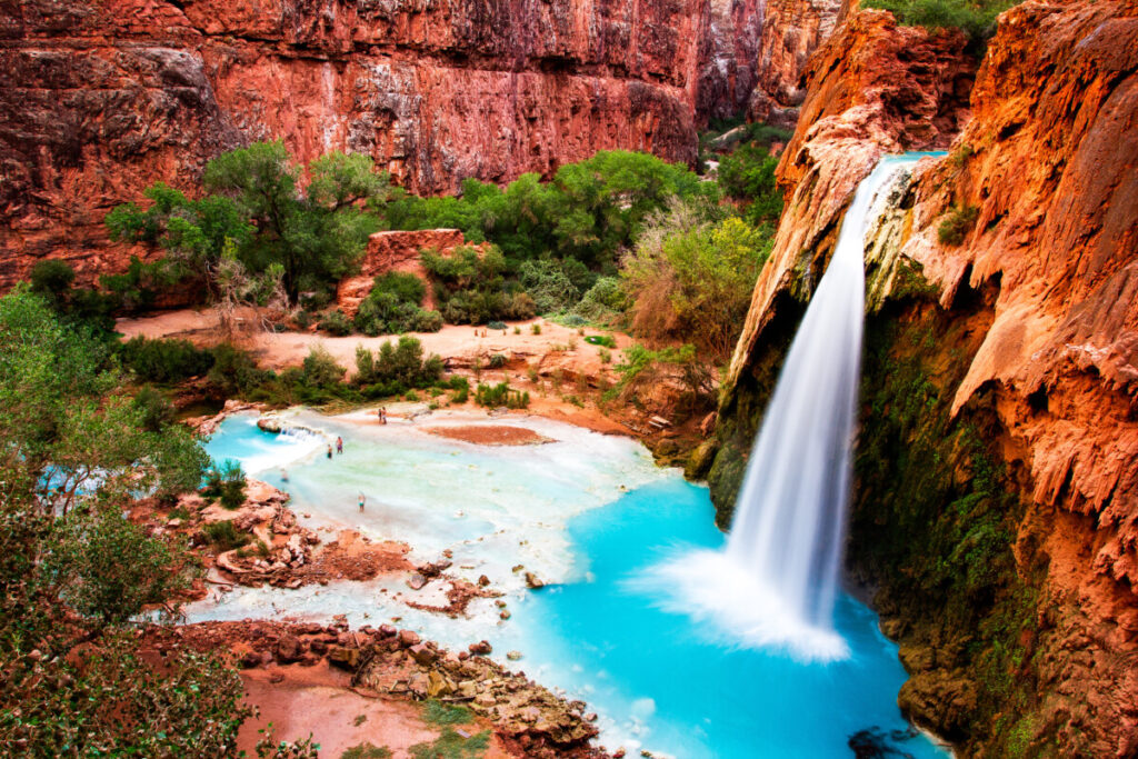 Aerial view of tourists swimming and basking the Havasu Falls Waterfall