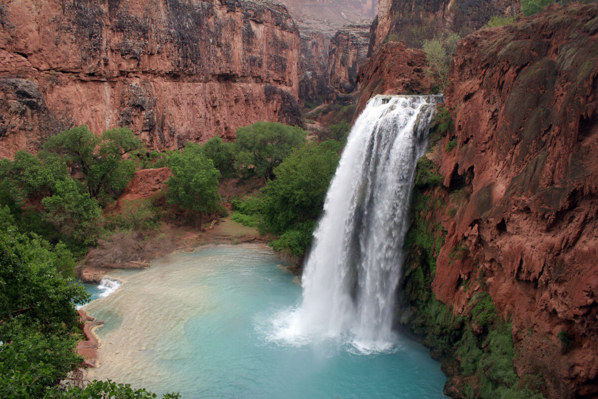 Havasu Falls on the Havasupai Reservation, Arizona, a turquoise pool waterfall amid red canyon walls.