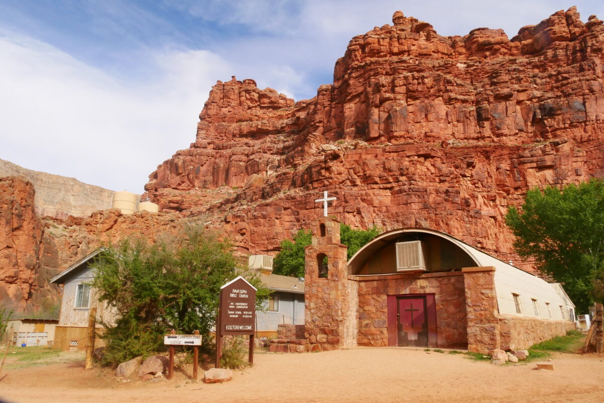Havasupai Supai Village Church under red canyon cliffs in Arizona, a Grand Canyon religious landmark.