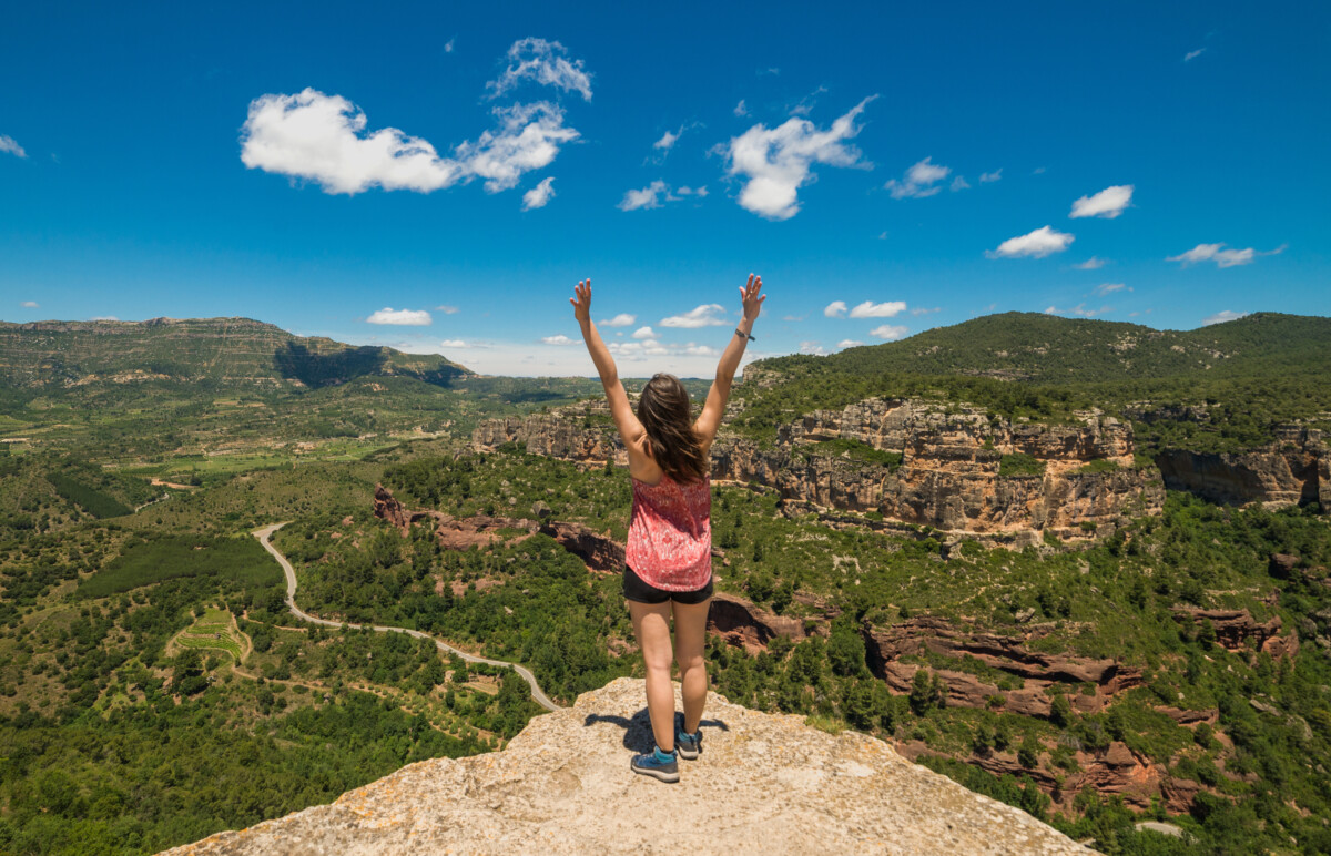 Woman on a hiking adventure with  arms wide open