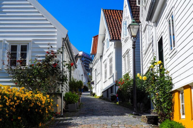 Colorful historic street in Old Stavanger, Norway, with wooden houses and vibrant flowers