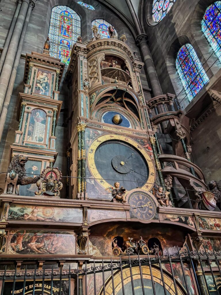 Historic astronomical clock in Strasbourg Cathedral, showcasing intricate dials and gothic architecture
