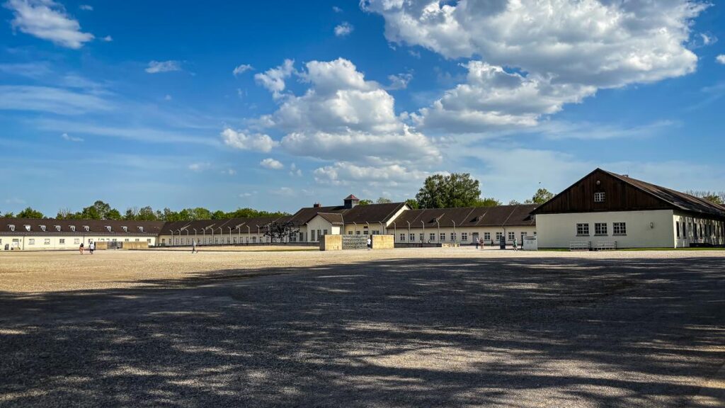 Historic Dachau Concentration Camp Memorial Site with original barracks and reconstruction under blue sky