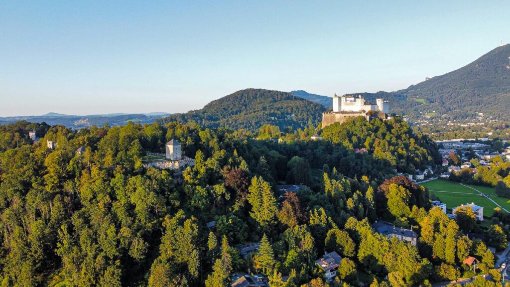 Aerial view of Hohensalzburg Fortress amid greenery in Salzburg