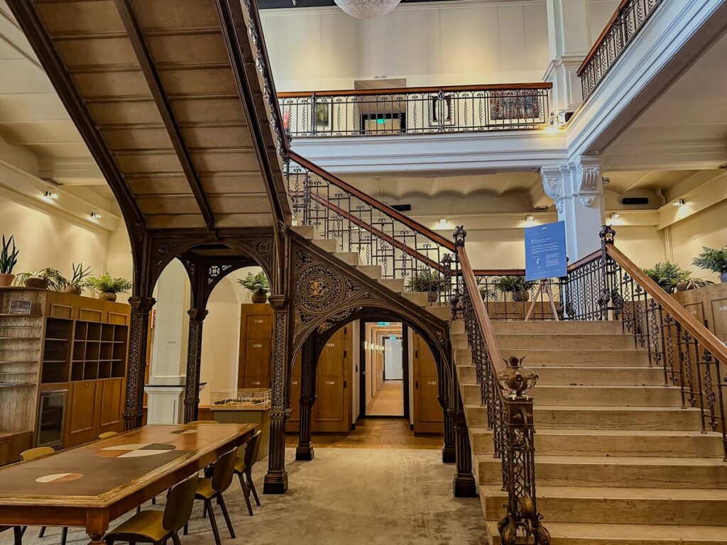 Elegant wooden staircase inside Hotel Arena, Amsterdam showcasing historic architecture and design.