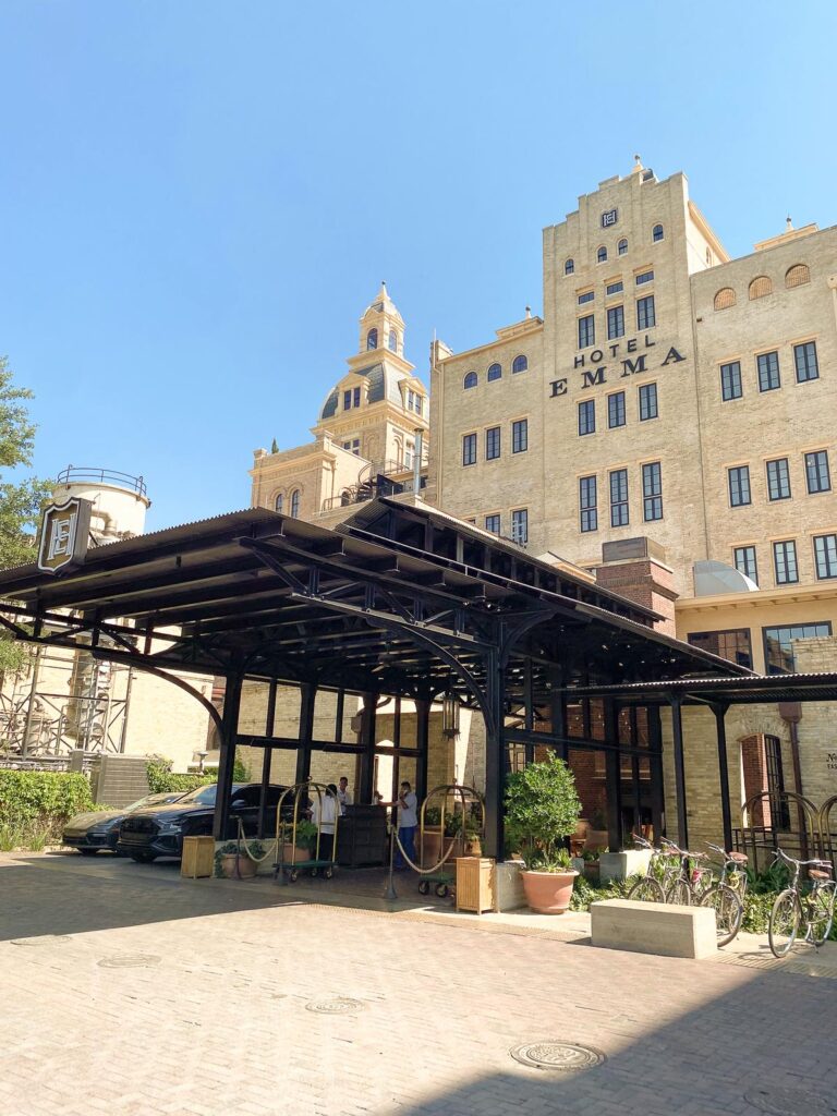 Hotel Emma San Antonio luxury entrance historic charm sRGB colors urban oasis.