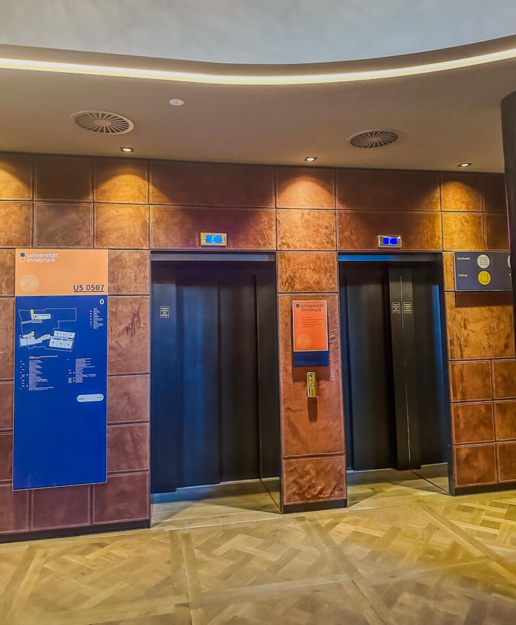 Hotel Grauer Bär elevator lobby, modern design, amber lighting, alpine luxury