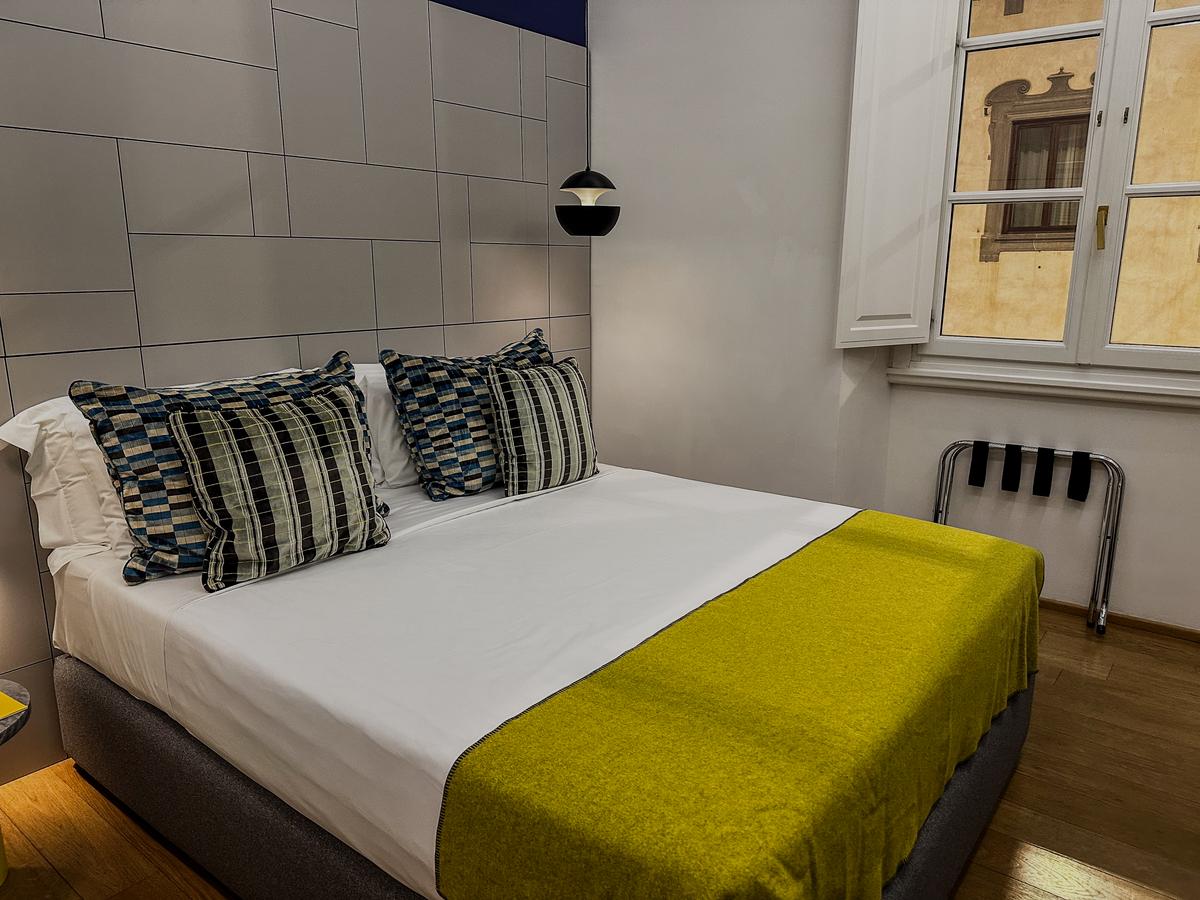 Elegant Hotel Milu bedroom interior with modern design and Florentine view