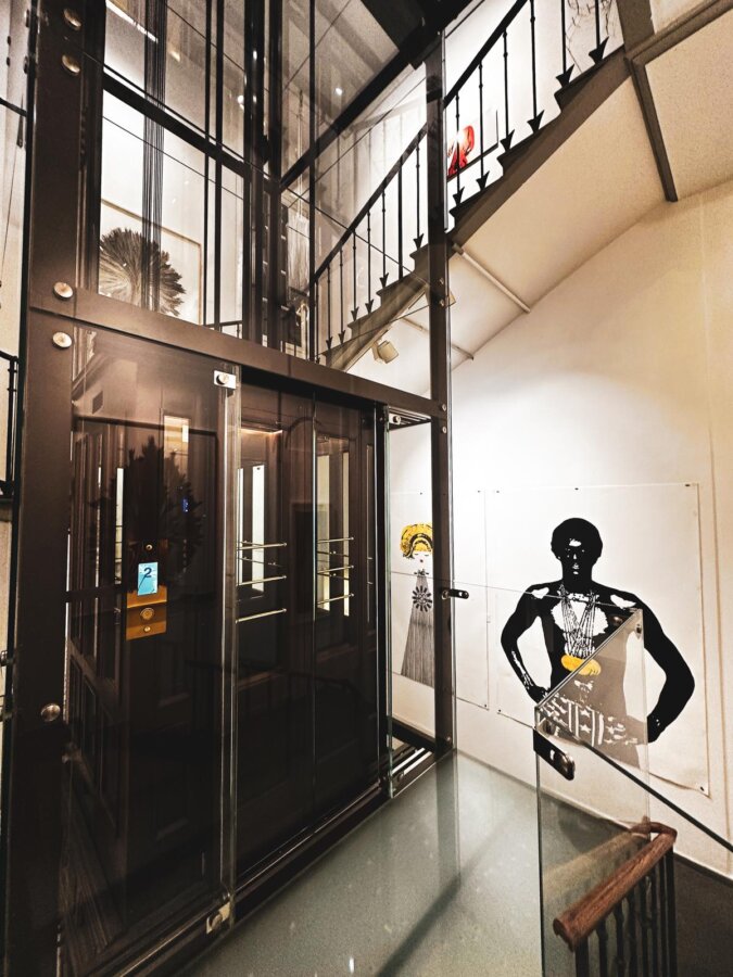 Hotel Milu Florence interior with modern elevator and classic staircase