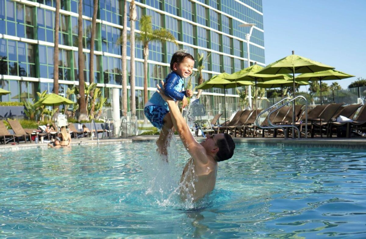 Parent and child at the pool at the Hyatt Regency, Long Beach, California