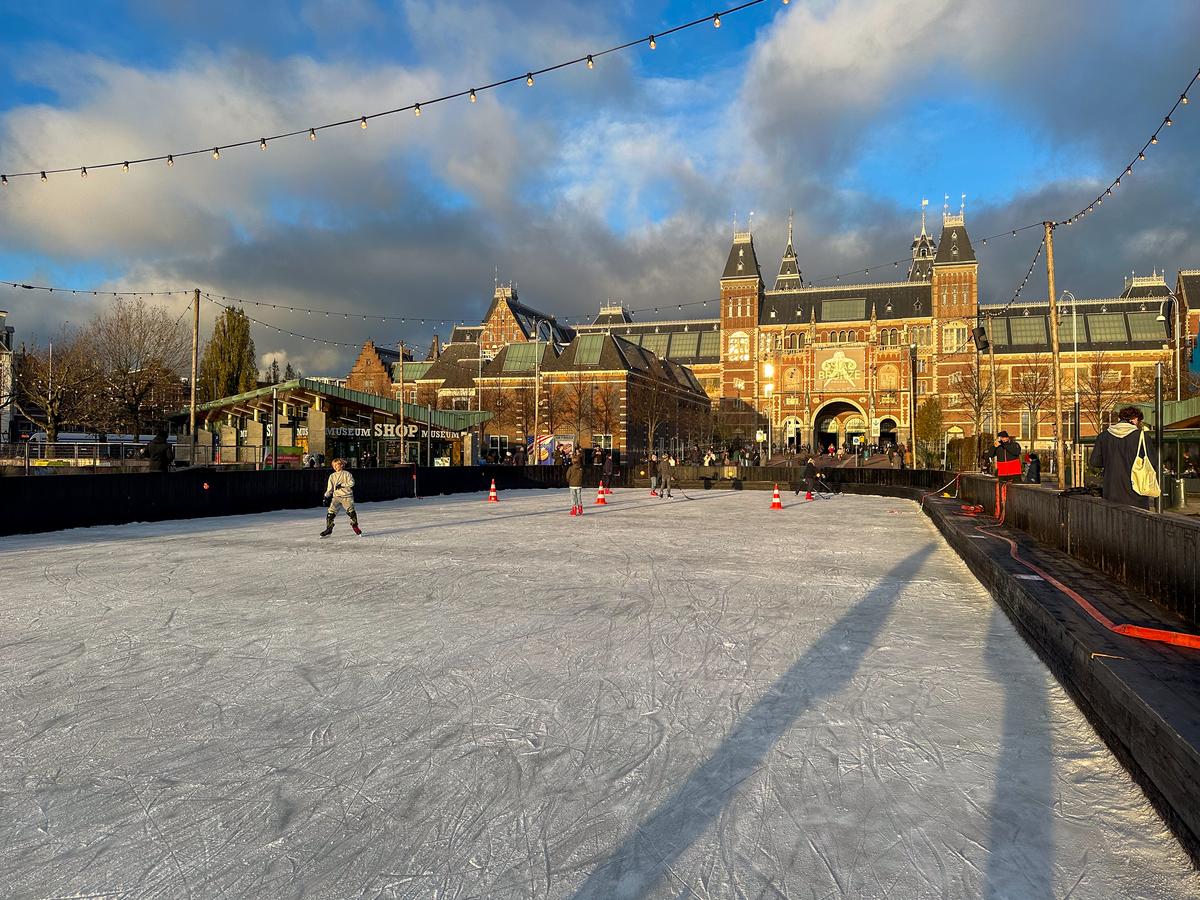 Ice skating at Amsterdam's Rijksmuseum in front of Museumplein during winter
